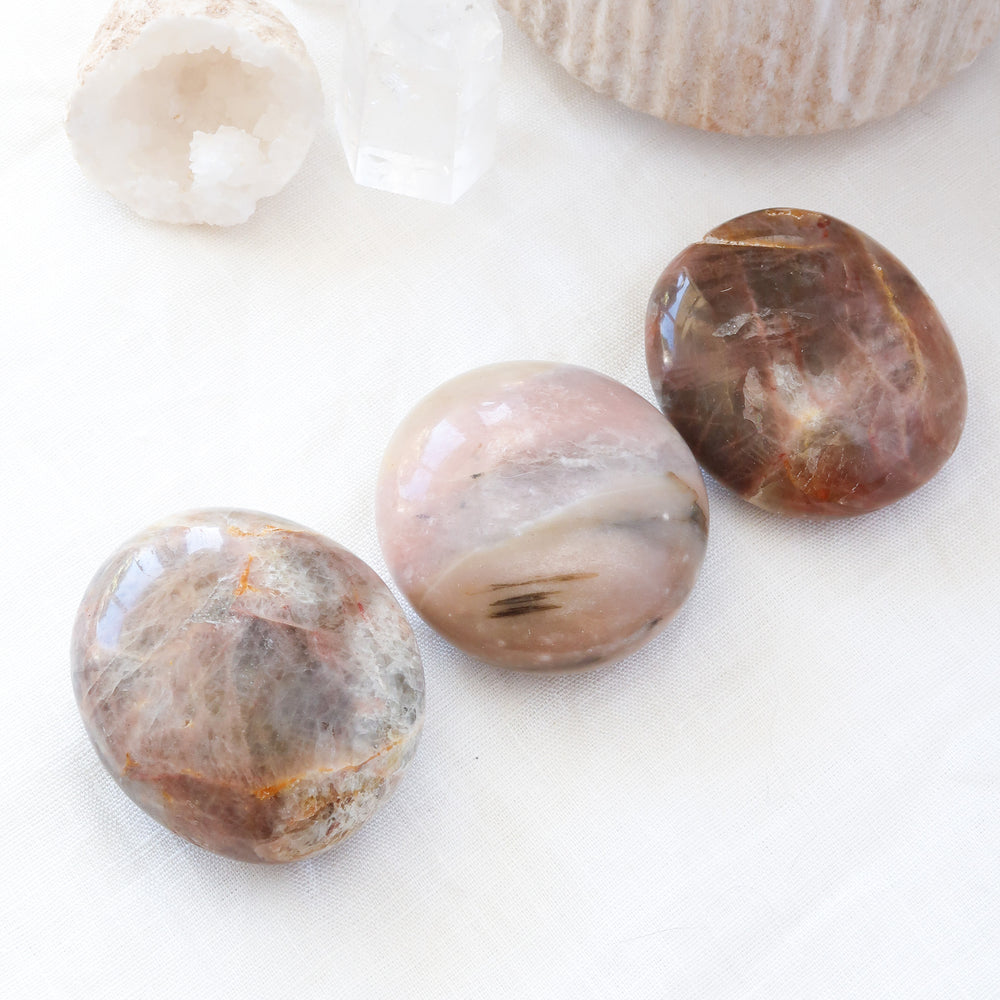 Three Polished Natural Black and Pink Moonstone Crystal Palm Stones